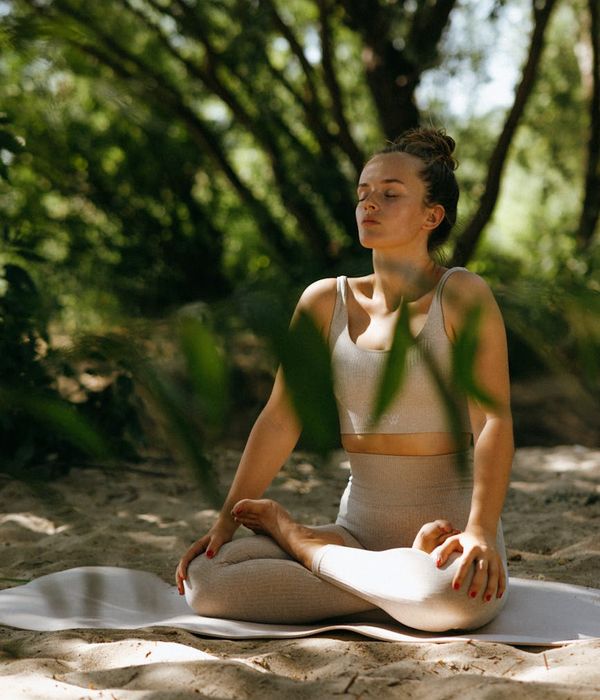A person sitting in a meditative pose, symbolizing inner balance and tranquility.